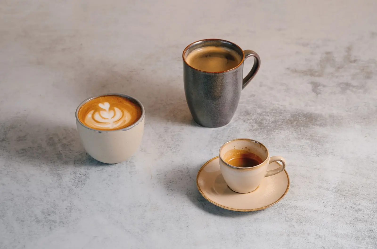 Several ceramic coffee cups arranged on a table.